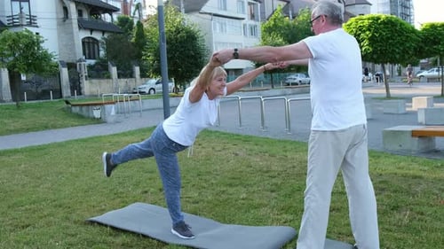 Yoga in the Park Senior Couple Exercising Outdoors Healthy Lifestyle Concept