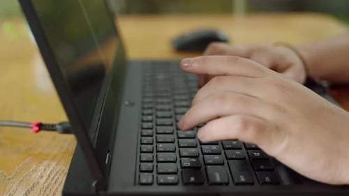 Closeup on Coders Hands Typing on Laptop Programming Software at Wooden Desk Developer Writes Code