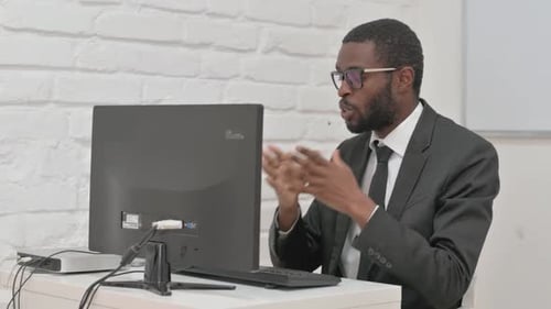Young Adult Talking During Online Meeting At Computer