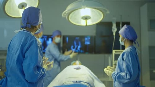 Doctor explain to his team about the process to treat patient in operation room of hospital