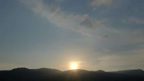 Mountains Silhouetted Against the Setting Sun in the Sky