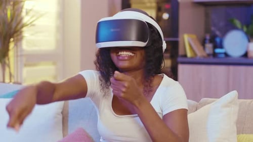 Woman Wearing VR Headset on Sofa at Home