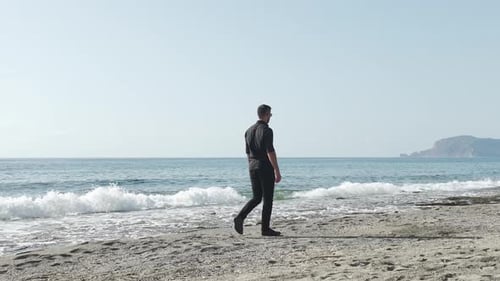 Aerial View Against the Azure A Man in Black on the Sands