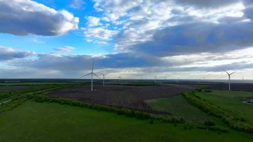 Wind Turbines On A Cloudy Summer Day In The Fields