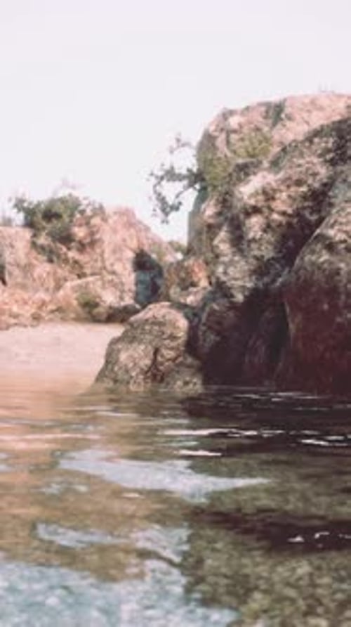 Rocky Cliff Overlooking Scenic Body of Water