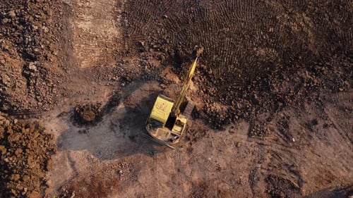Excavator dig ground at construction site. Aerial view of a wheel loader excavator with a backhoe