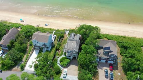 Drone Circling Cape Cod House Near Shoreline
