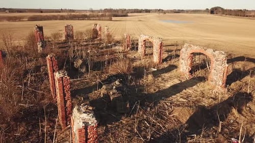 An abandoned stone ruins from medieval age casting shadow on to the ground.