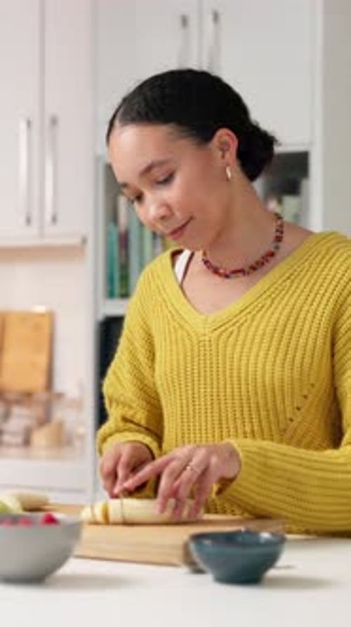 Woman, cooking or chop fruit in kitchen with knife for healthy nutrition, organic meal or breakfast
