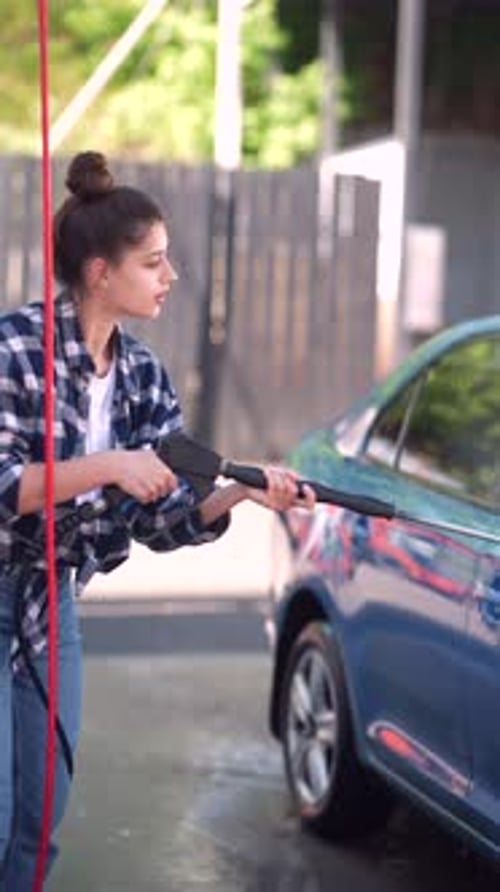 A Highpressure Water Gun is Utilized to Wash the Car Effectively