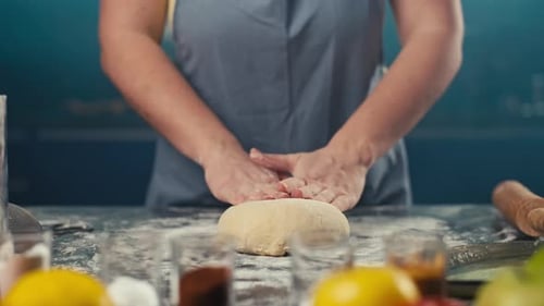 Woman Kneading Dough on Floured Kitchen Counter