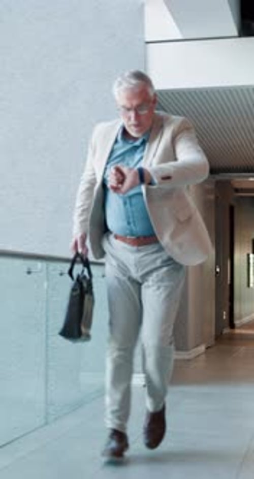 Panic, urgency and watch with business man in workplace hallway for delay or rushing