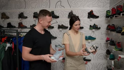 Man and Woman Selecting Shoes in Store