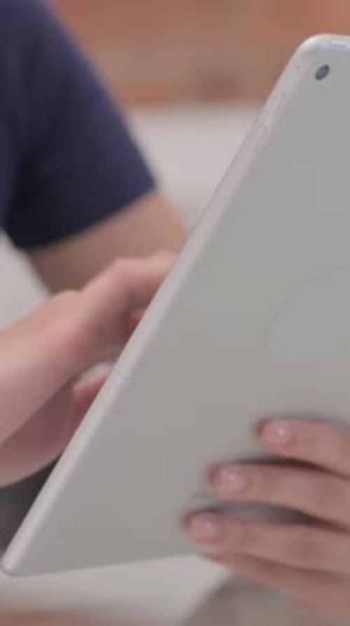Close up of Latina Female Hand Using Tablet, vertical