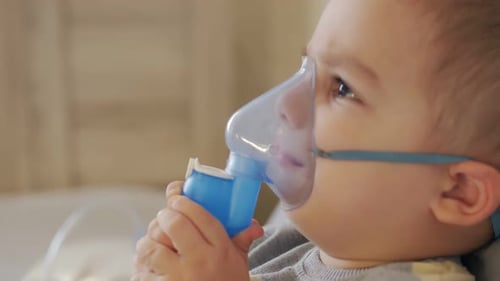 Young Child Using Nebulizer Mask for Respiratory Treatment