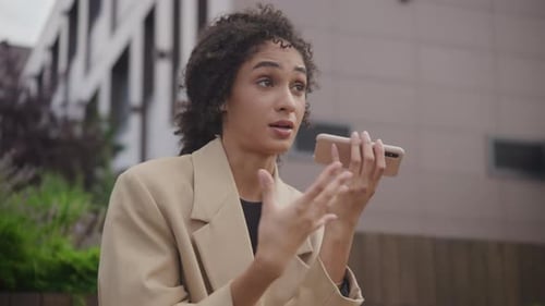 Young Woman Talking on Mobile Phone Outdoors