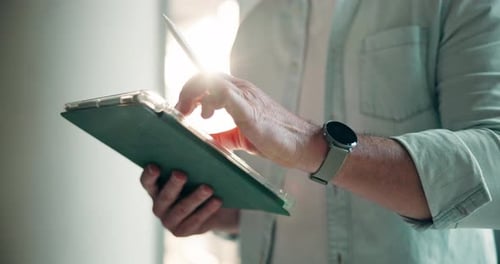 Person Using Stylus Pen on Tablet Device