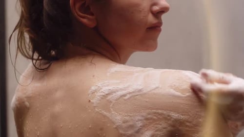 Woman Washing with Soap and Sponge in Shower