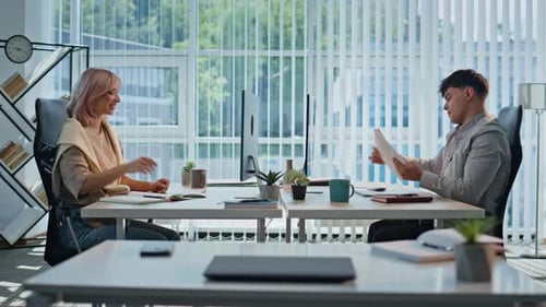Woman Giving Papers Colleague at Panoramic Office Two Coworkers Communicating