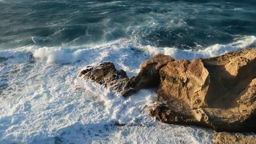 Ocean Waves Crashing Against Rocky Coastline