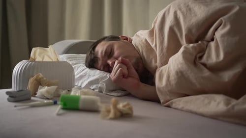 Sick Man Resting in Bed at Home