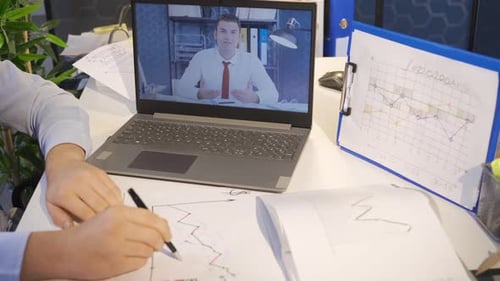 Reviewing Charts on Video Call in Office