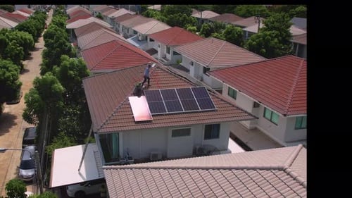 Drone view of engineer worker installed solar panels on roof of house.