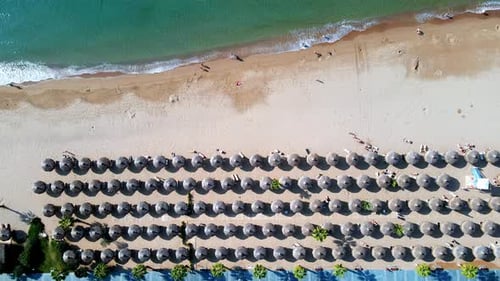 Aerial View of Umbrellas Palms on the Sandy Beach People Blue Sea with Waves at Sunset