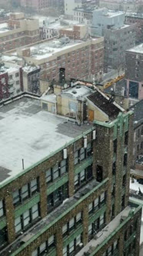 A Breathtaking View Capturing Snowy Rooftops Over a Sprawling Urban Landscape in Winter