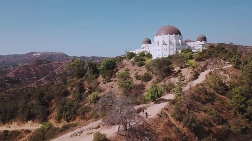 LA: Drone shot of Griffith Observatory moving towards the Hollywood Sign in the distance