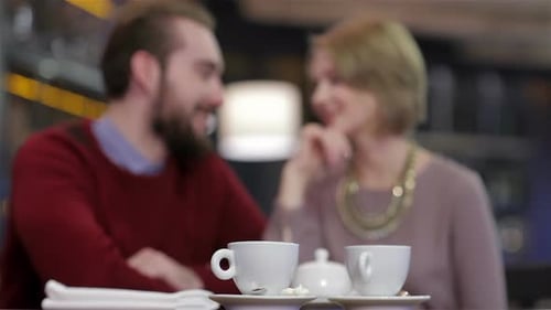 Two Young People in Cafe Enjoying the Time Spending with Each Other