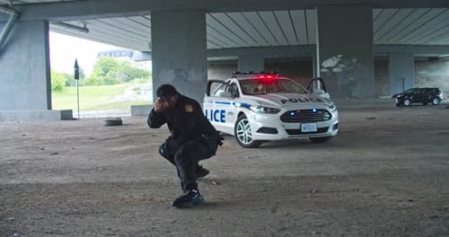 A Dedicated Police Officer Under an Overpass Focusing on Community Safety and Security