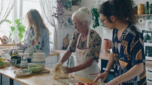 Three Women Cooking Together in a Bright Kitchen