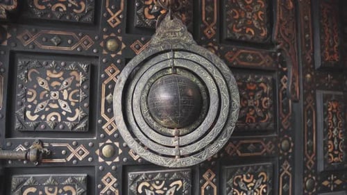 Ancient stylish globe artifact with interesting patterns hanging in store of Morocco market, handhel