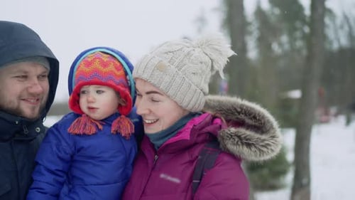 Loving Family Portrait in Snowy Winter Scene