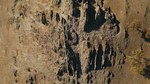 Măcin Mountains, Tulcea County, Romania - Jagged Rock Formations Rise from a Dry, Rugged Hillside,