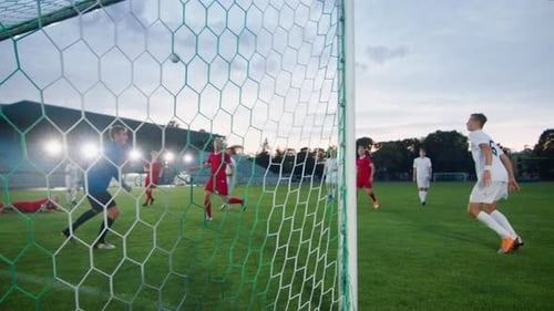 On Soccer Championship Player Scores the Goal Hitting Ball with His Head, Goalkeeper Tries to Defen