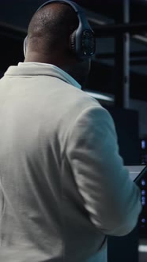 Vertical Video Software Developer in Data Center Workspace Coding on Tablet