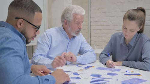 Office Team Analyzing Data Reports Together