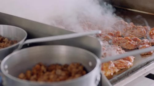 Steaming Food Cooking on Griddle in Daytime Kitchen