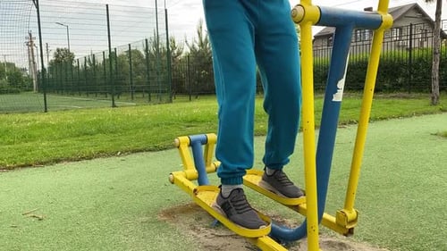 A male athlete works out at the outdoor gym