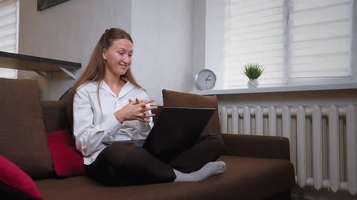 Smiling Woman on Laptop Video Call From Home