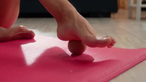 Close Up Unrecognizable Woman Massaging Leg Foot with Sport Rubber Ball at Home Floor Girl Female