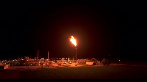 Gas Flaring Brightens the Plant With its Illumination - Aerial Pullback