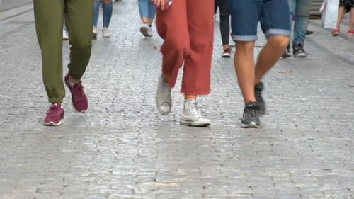 Concept crowd feet with shoes closeup. Anonymous people walking on the street. Legs of Crowd People