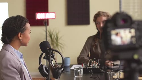 Two Young Multiethnic Women Recording Video Podcast