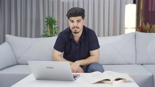 Young Adult with Laptop Sitting on Couch