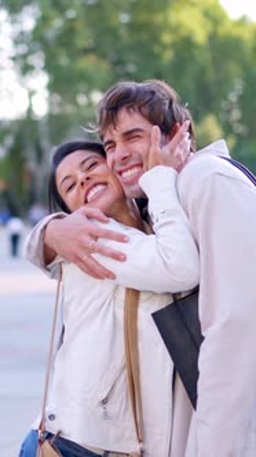 Romantic Couple Embraces and Kisses Affectionately Outdoors