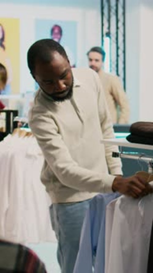 Vertical Video Modern Man Shopping for Formal Wear in Clothing Store