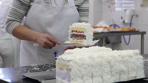 Witness cake artistry at its finest: close-up shot captures a chef skillfully creating delightful ca
